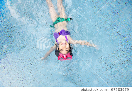 asian kid big smile to playing swim in water pool asian kid big smile to playing swim in water pool 67583979