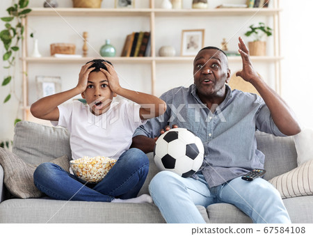 Lost Goal. Disappointed Black Grandfather And His Grandson Watching Football On TV 67584108