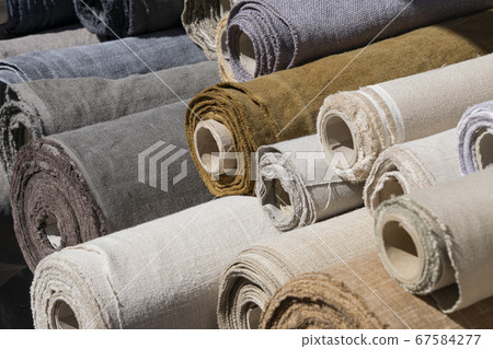 Rolls of linen canvas textile on market stall 67584277