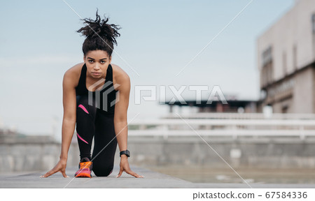 Start training or marathon. Girl in sportswear at start, is ready to run 67584336