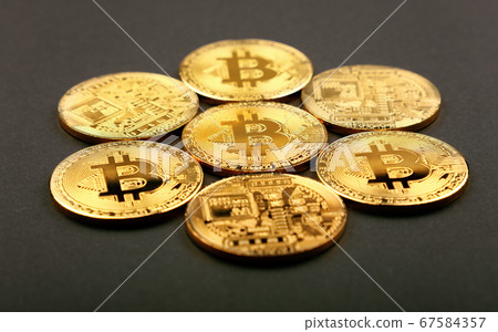 Gold bitcoin physical coins over black Gold bitcoin physical coins over black 67584357