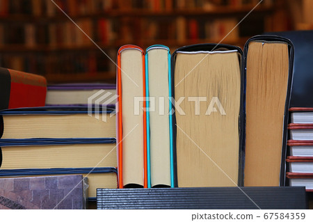 Books back on wooden shelves of store close up Books back on wooden shelves of store close up 67584359