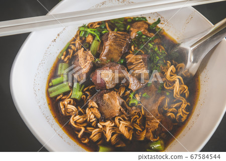 Braised pork noodles in Thai style. 67584544