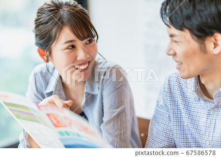 男人和女人在看旅行手冊時制定計劃 男人和女人在看旅行手冊時制定計劃 67586578