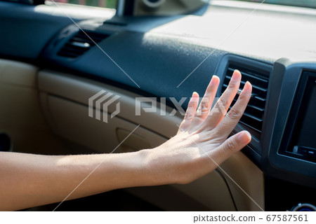 Closeup of hand woman checking flow cold from air conditioner in new car,Cooling system in car,Auto air conditioning 67587561