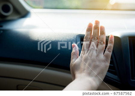 Closeup of hand woman checking flow cold from air conditioner in new car,Cooling system in car,Auto air conditioning Closeup of hand woman checking flow cold from air conditioner in new car,Cooling system in car,Auto air conditioning 67587562