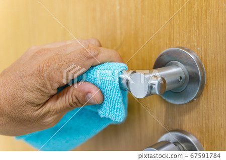 Prevention cleaning Door handles by Disinfectant solution for killing corona virus on touching surfaces, concept coronavirus COVID19 Prevention cleaning Door handles by Disinfectant solution for killing corona virus on touching surfaces, concept coronavirus COVID19 67591784