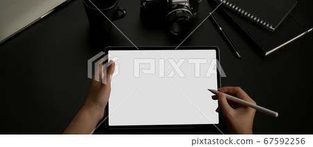 Female hands using mock up tablet with stylus on 67592256