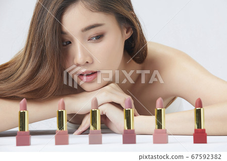 Beautiful woman beauty cosmetics lipstick selection lost white background person material Beautiful woman beauty cosmetics lipstick selection lost white background person material 67592382
