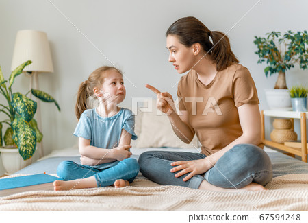 mother is scolding her child girl. 67594248