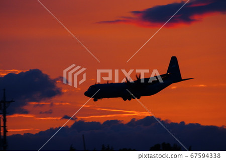 C-130 Hercules flying in the dusk C-130 Hercules flying in the dusk 67594338