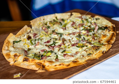 Tarte Flambee, ATraditional French Dish. Fresh Baked In A Wood-Fired Traditional Adobe Oven Flame Cake Tarte Flambee, ATraditional French Dish. Fresh Baked In A Wood-Fired Traditional Adobe Oven Flame Cake 67594461