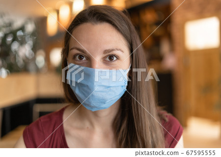 New normal concept of woman with mask eating in restaurant New normal concept of woman with mask eating in restaurant 67595555