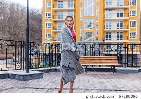 A beautiful woman in a coat on the urban A beautiful woman in a coat on the urban 67599066