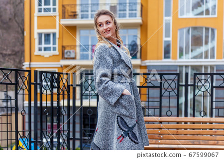 A beautiful woman in a coat on the urban A beautiful woman in a coat on the urban 67599067