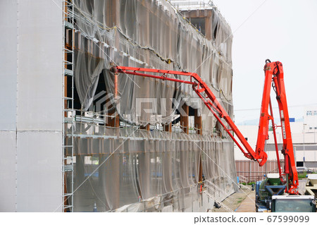 Concrete pouring on concrete pump truck at construction site 67599099
