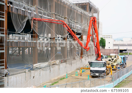Concrete pouring on concrete pump truck at construction site Concrete pouring on concrete pump truck at construction site 67599105