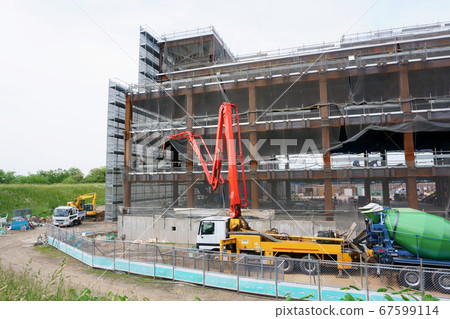 Concrete pouring on concrete pump truck at construction site 67599114