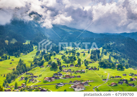 Alpine scenery with traditional mountain chalets in Switzerland Alpine scenery with traditional mountain chalets in Switzerland 67599700