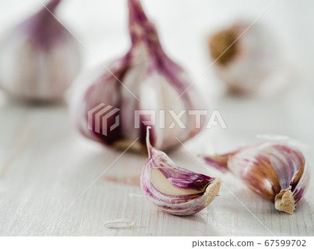 Garlic bulb on white wooden background Garlic bulb on white wooden background 67599702