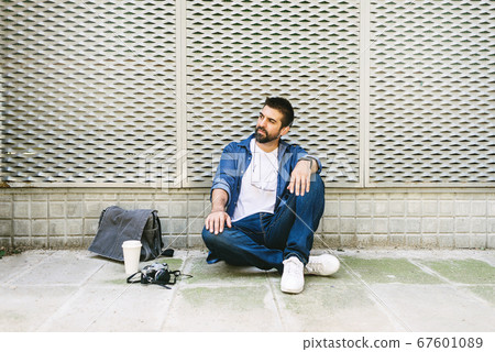 Portrait of a bearded man in casual attire sitting 67601089