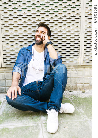 Portrait of a bearded man in casual attire sitting Portrait of a bearded man in casual attire sitting 67601091