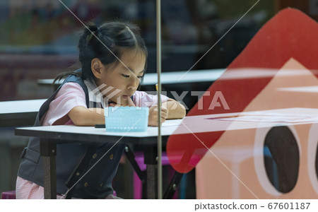 kindergarten student focused on studying kindergarten student focused on studying 67601187