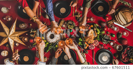 Flat-lay of family clinking glasses at Christmas 67601511