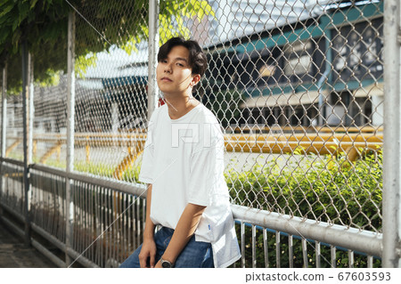 Guy at the fence. Guy at the fence. 67603593