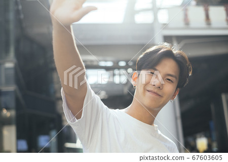 Hand up and smile. 67603605