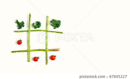 tic tac toe with food, asparagus kale, tomato, top view tic tac toe with food, asparagus kale, tomato, top view 67605227