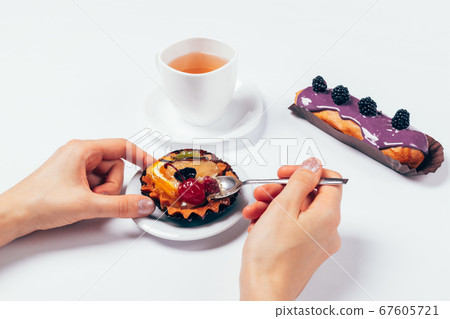 Close-up woman eats cake with spoon Close-up woman eats cake with spoon 67605721