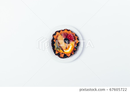 Tartlet with glazed fruits and berries Tartlet with glazed fruits and berries 67605722