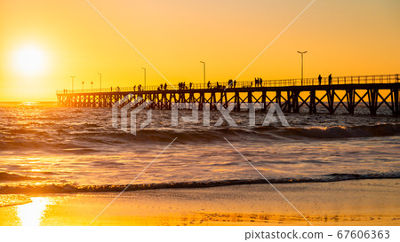 Fishermen on Port Noarlunga jetty at sunset Fishermen on Port Noarlunga jetty at sunset 67606363