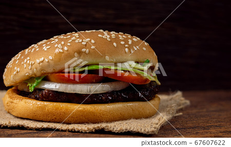 Hamburger meat and vegetables on wooden background Hamburger meat and vegetables on wooden background 67607622