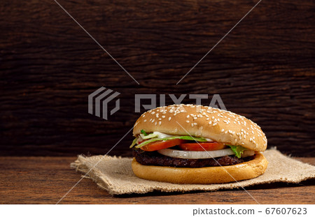 Hamburger meat and vegetables on wooden background Hamburger meat and vegetables on wooden background 67607623