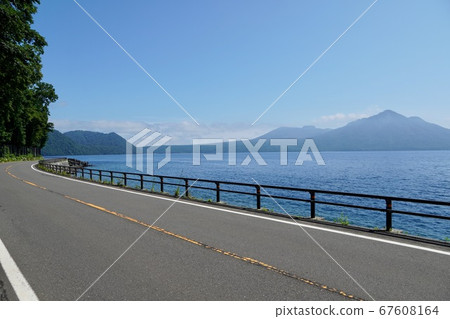 Windy Mt.Fuji and Tarumae seen from the national highway on the shore of Lake Shikotsu 67608164