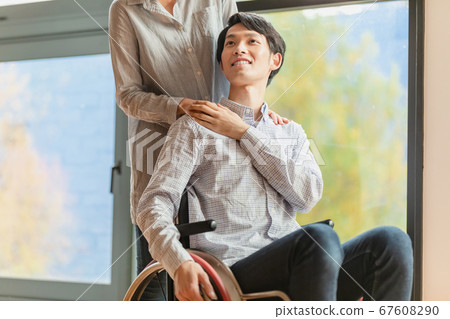 Man and woman couple in wheelchair Man and woman couple in wheelchair 67608290