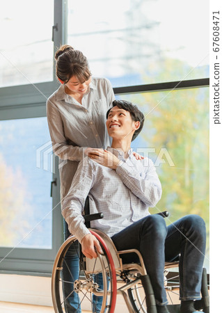 Man and woman couple in wheelchair Man and woman couple in wheelchair 67608471