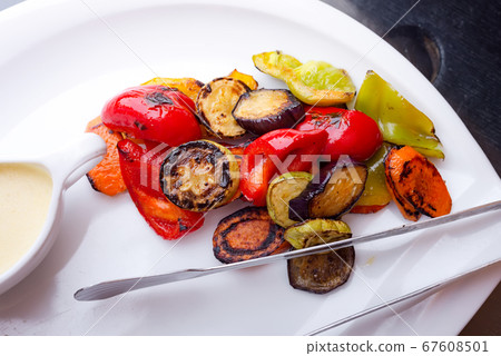 Fresh natural grilled vegetables with white sauce. 67608501