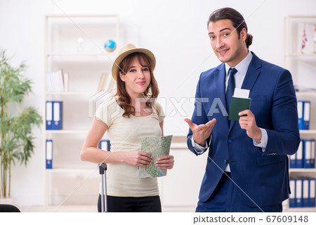 Young woman visiting embassy for visa 67609148