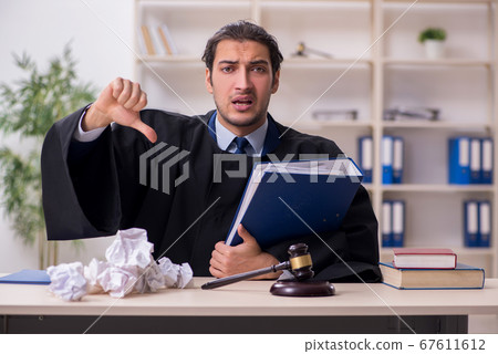 Young male judge working in courthouse 67611612