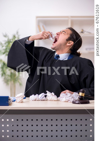 Young male judge working in courthouse Young male judge working in courthouse 67611619