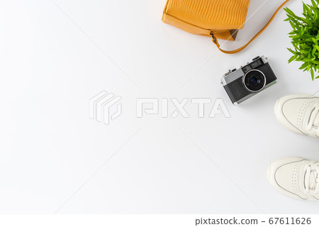 Woman lifestyle background with camera photo, purse and sneakers. Travel concept. Flat lay Woman lifestyle background with camera photo, purse and sneakers. Travel concept. Flat lay 67611626