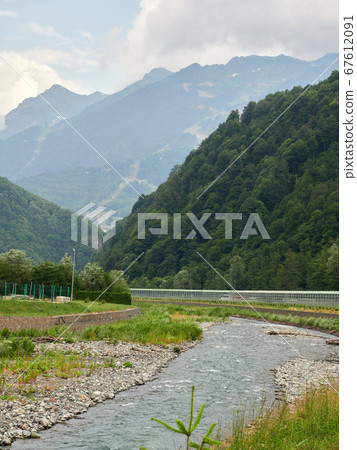 Small river between green mountains 67612091