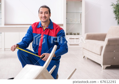 Young male carpenter working indoors Young male carpenter working indoors 67612291
