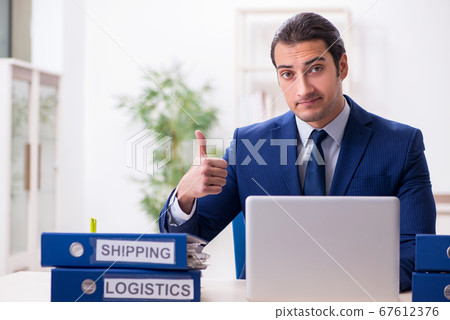 Young male logistics specialist working in the office 67612376