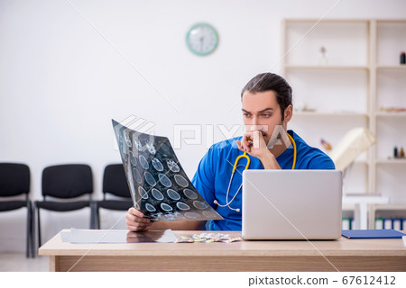 Young male doctor radiologist working in the clinic Young male doctor radiologist working in the clinic 67612412