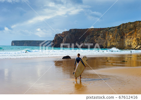 Surfer surfboard woman Portugal beach Surfer surfboard woman Portugal beach 67612416