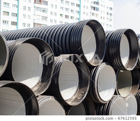Large diameter plastic pipes for supplying heating and water supply to the house. Modern method of laying durable pipes, chemical resistance, copy space. Industry Large diameter plastic pipes for supplying heating and water supply to the house. Modern method of laying durable pipes, chemical resistance, copy space. Industry 67612593